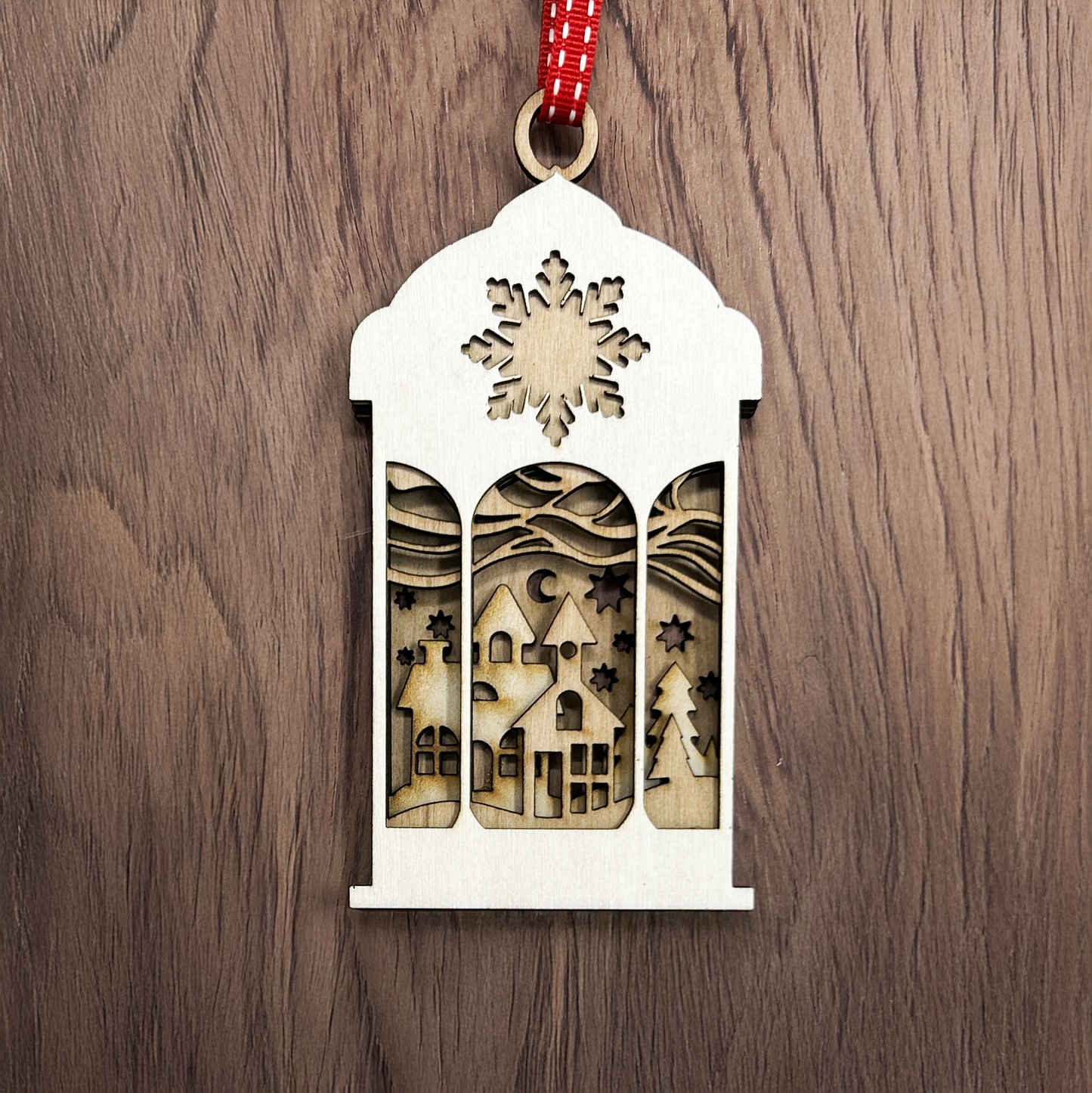 Christmas Tree ornament in the shape of a lantern with a village scene made from layers